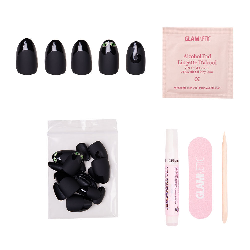 The glamnetic Nine Lives Nail Set showcases velvet-finish cat eye designs on black nails and comes with extra nails, alcohol pad, pink nail file, wooden cuticle stick, and glue—all displayed on a white background. - Product image