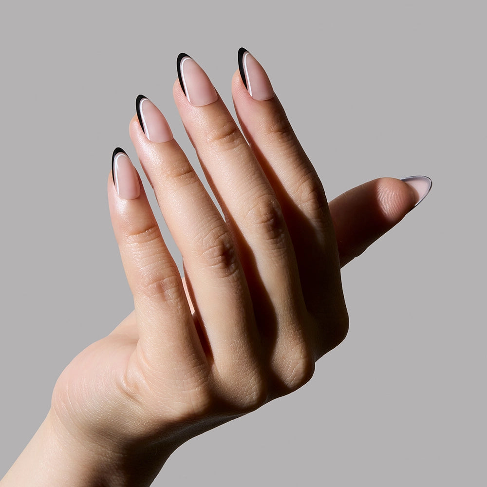 Hand with black and white nail design on a gray background - Product image
