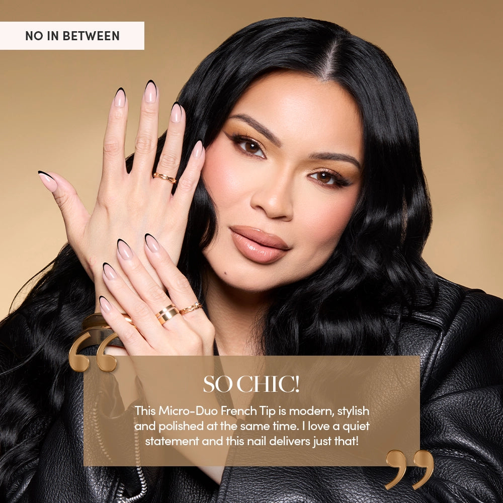 Glamzilla poses with her hands near her face, wearing a sleek black leather jacket and soft glam makeup. Her almond-shaped nails feature a Micro-Duo French Tip design—nude pink base with ultra-fine black tips. She wears stacked gold rings and cuffs. Overlay text reads:
“SO CHIC!”
“This Micro-Duo French Tip is modern, stylish and polished at the same time. I love a quiet statement and this nail delivers just that!” - Product image