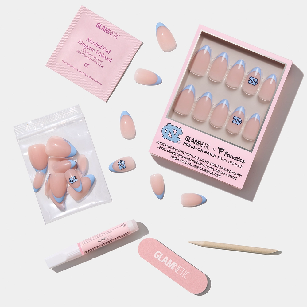 The glamnetic North Carolina Tar Heels Press-On Nail Set features salon-quality pink nails with Carolina-blue tips and UNC logos, plus an alcohol pad, nail glue, wooden stick, nail file, and extra nails—all on a white background. - Product image