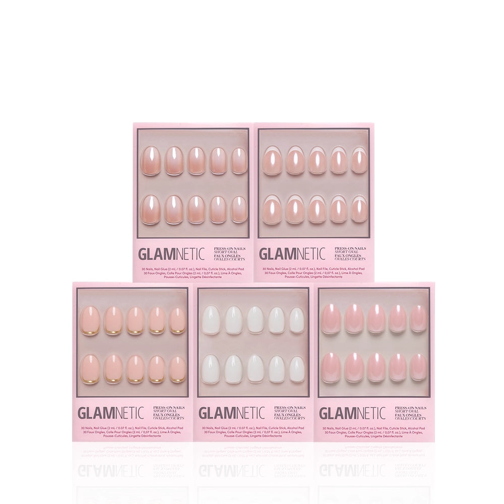 Five sets of glamnetic Ovals in the Nude salon-quality press-on nails, each packaged in a pink box and showcasing a different pastel or nude oval design—ranging from short oval shapes to classic neutral tones—are neatly arranged in two rows against a white background. - Product image