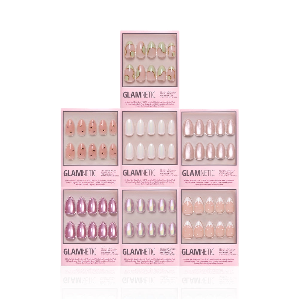 Seven boxes of glamnetic Desert Muse nail sets are arranged in a pyramid, each showcasing different styles—pinks, nudes, whites, and iridescent festival nails—in clear packaging for salon-quality nails at home. - Product image