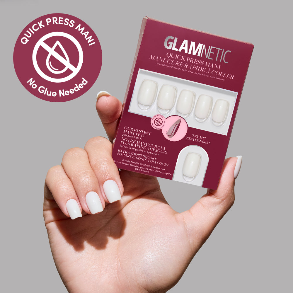 A hand with white press-on nails holds a glamnetic Quick Press Mani box for the "Porcelain" style. The packaging and a pink badge highlight that no glue is needed for these nails.