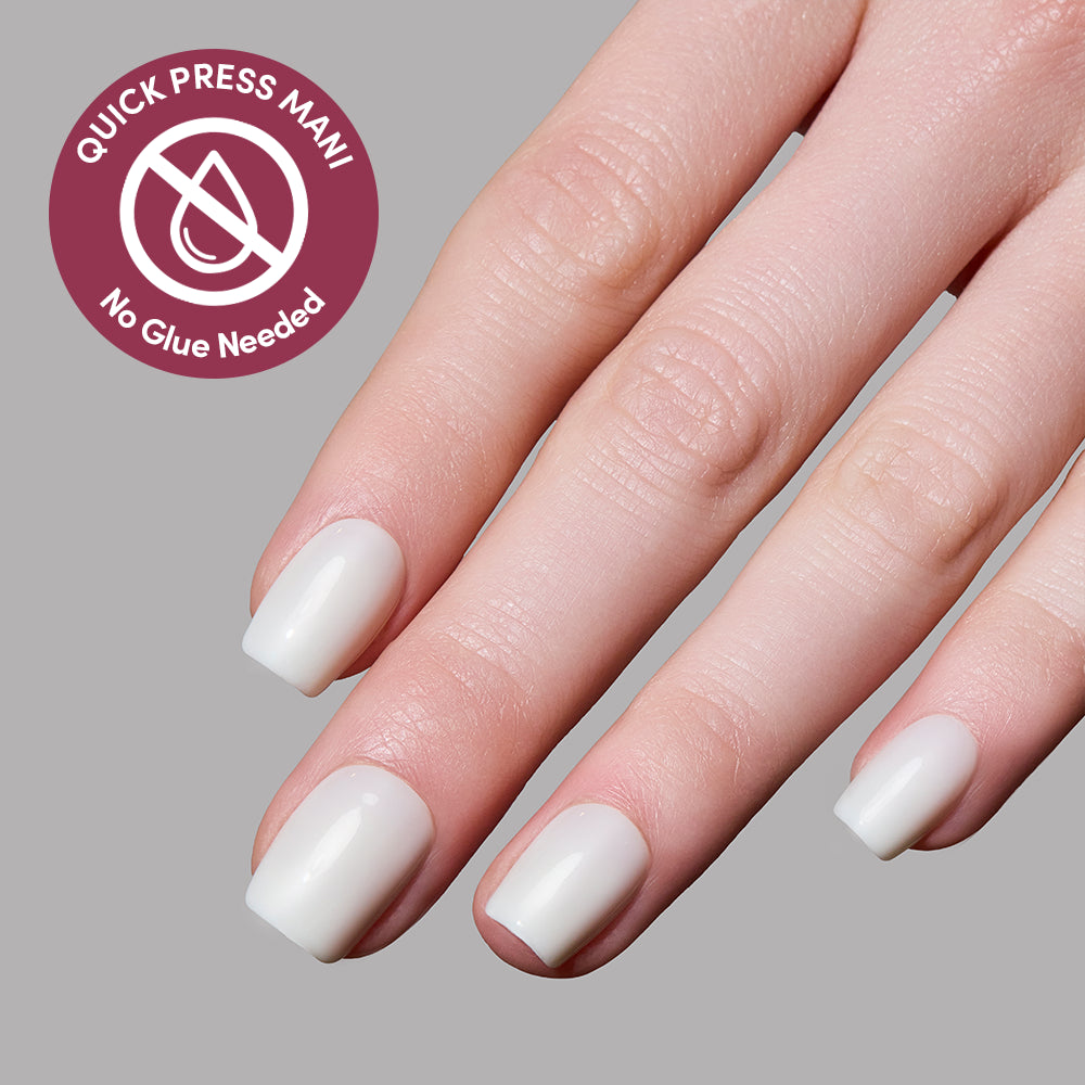 A hand with short, glossy, white Porcelain press-on nails by glamnetic against a gray background. A circular icon reads Quick Press Mani, No Glue Needed beside the hand, highlighting these easy stick-on nails. - Product image