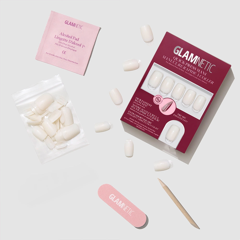 The glamnetic Porcelain press-on nails kit includes packaging, nail glue, alcohol pad, nail file, cuticle stick, and extra nails—everything you need for flawless stick-on nails at home on a light gray background. - Product image