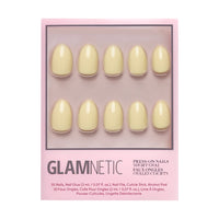 A package of glamnetic Pastel Yellow nail set features 10 short oval, solid pale yellow salon-quality nails with a glossy finish, displayed on a pink backing and visible through a clear window.