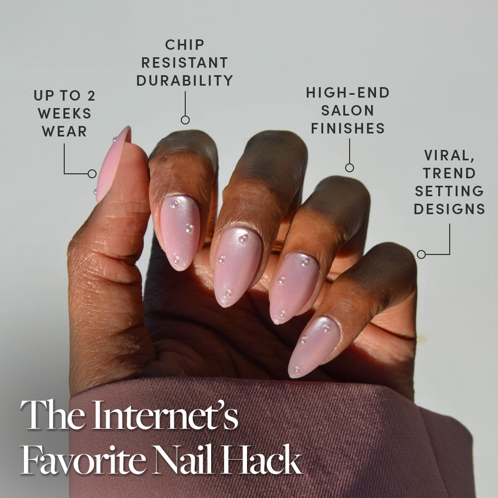 A hand shows off glamnetic’s Pearl Me Softly: long, glossy blush-pink almond nails with gem accents. Enjoy up to 2 weeks’ wear, chip resistance, high-end finishes, and trendsetting style. Caption: The Internet’s Favorite Nail Hack. - Product image