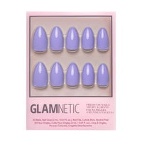 A box of glamnetic Periwinkle press-on nails in short almond shape, featuring 10 glossy periwinkle nails in two rows on a light pink background. Pack includes nail glue and application tools.