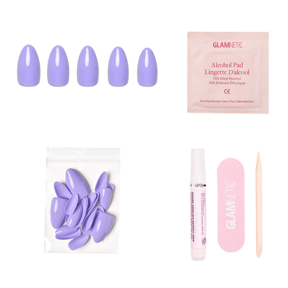 The Periwinkle press-on nails set by glamnetic includes glossy nails, an alcohol pad, extra nails, a nail glue tube, a pink file, and a wooden cuticle stick neatly arranged on a white background. - Product image