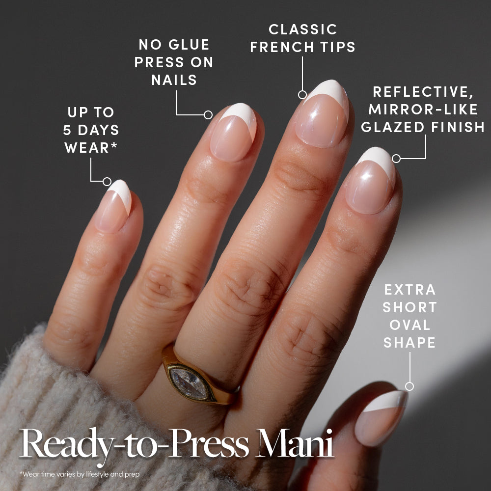 Hand wearing Petite Pearls glazed French tip extra short oval press-on nails, featuring no-glue application and five-day wear. - Product image