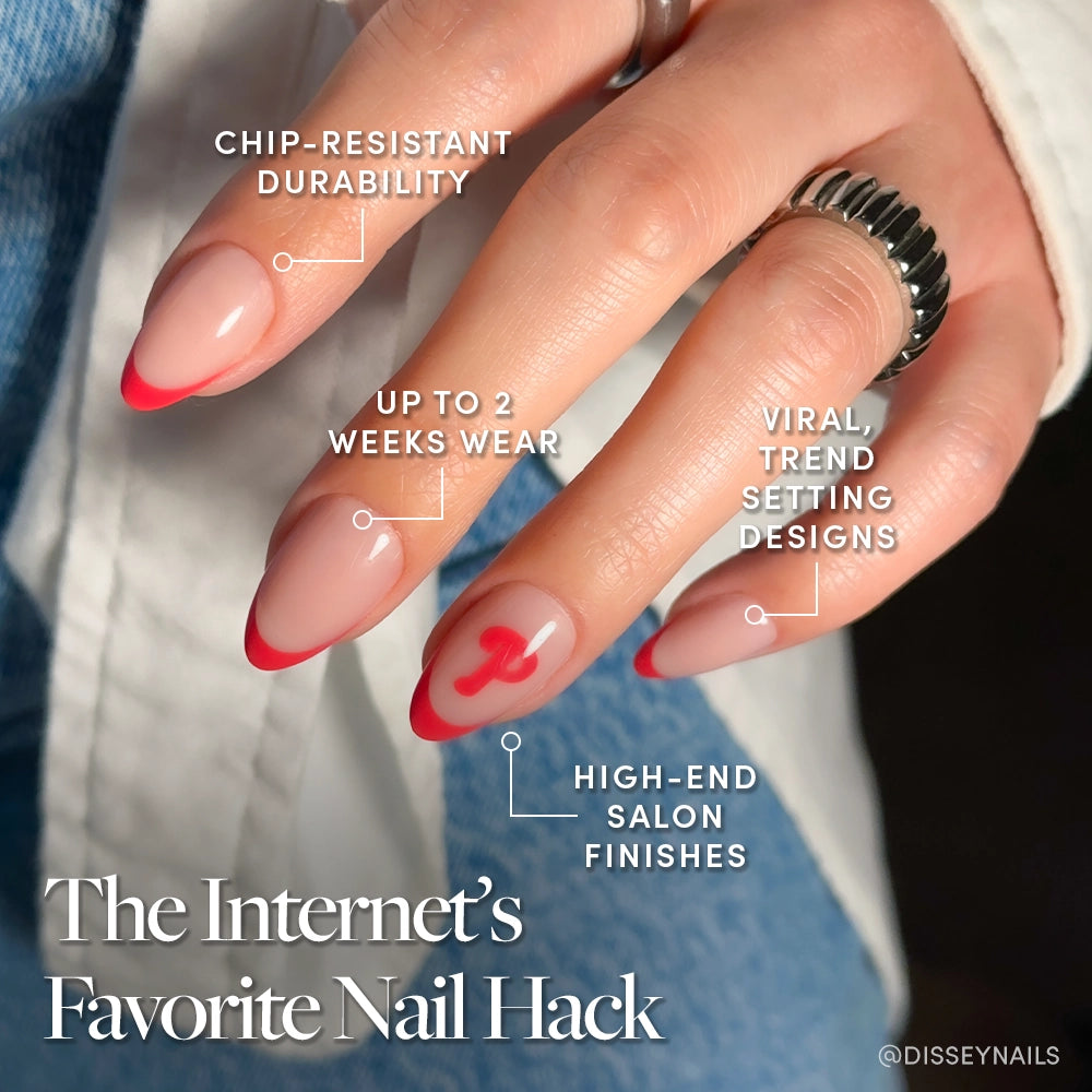 A manicured hand shows glamnetic’s Philadelphia Phillies Press-On Nail Set with a pink base, bright red tips, and a red h accent. These nails offer trendy designs, chip-resistant durability, up to 2 weeks of salon-quality wear. - Product image