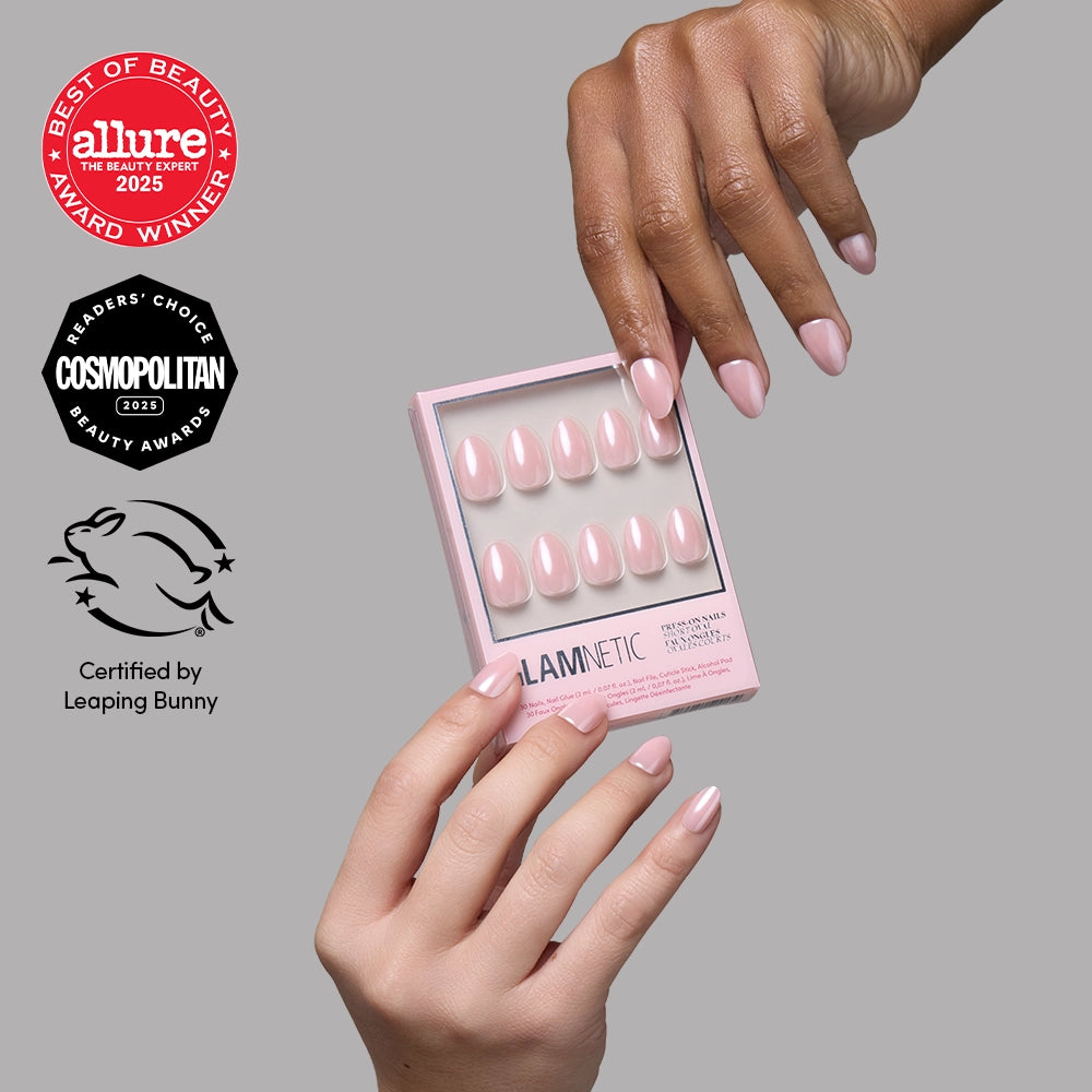 Pinch Me - Hands holding a box of blush pink short oval Pinch Me press-on nails by glamnetic, displayed alongside Allure and Cosmopolitan award logos and a Leaping Bunny cruelty-free certification icon.