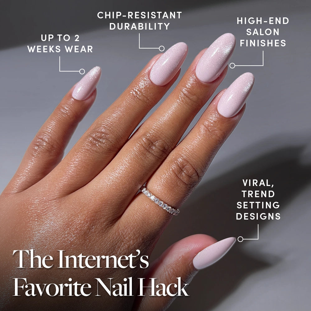 A hand with long, glossy pale pink Pink Darling nails by glamnetic, wearing a thin diamond ring. Features: up to 2 weeks wear, chip-resistant, high-end finish, trendy design. Bottom text: The Internet’s Favorite Nail Hack. - Product image