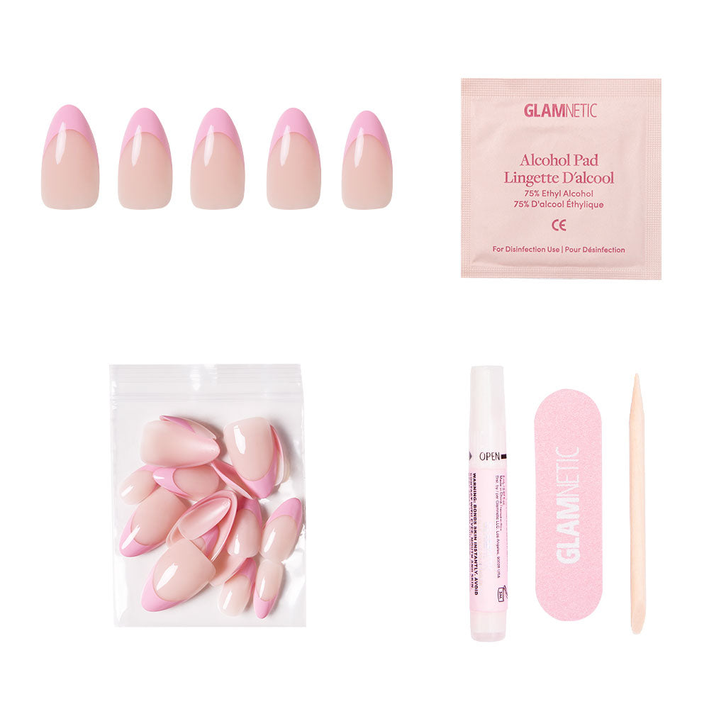 The glamnetic Pink Macaron Nail Set includes almond base pink French tip nails, extra nails in a small bag, nail glue, an alcohol pad, a pink file, and a wooden cuticle stick, all displayed on a white background. - Product image