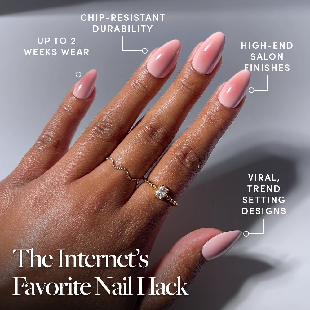 A hand with pink, almond-shaped nails showcases the glamnetic Pink Petalite press-on set, featuring up to 2 weeks of wear, chip-resistant durability, high-end salon finishes, and trend-setting viral designs—all in easy-to-apply short almond shapes for The Internet’s Favorite Nail Hack. - Product image