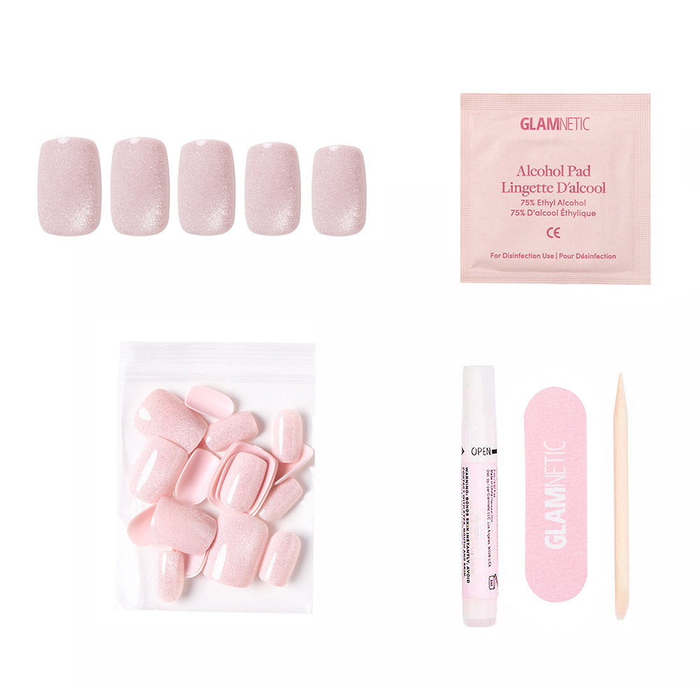 The glamnetic Pinky Promise kit includes short squoval blush velvet press-on nails, reusable and extra nails, glue, a pink file, an alcohol pad, and a cuticle stick—all arranged on a white background. - Product image