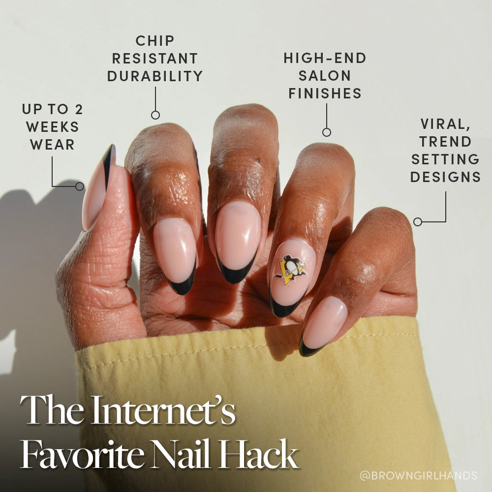 Show off almond-shaped nails with a pink base, black tips, and a floral accent using the Pittsburgh Penguins Press-On Nail Set by glamnetic—enjoy up to 2 weeks of chip-resistant wear and a salon-quality finish. - Product image