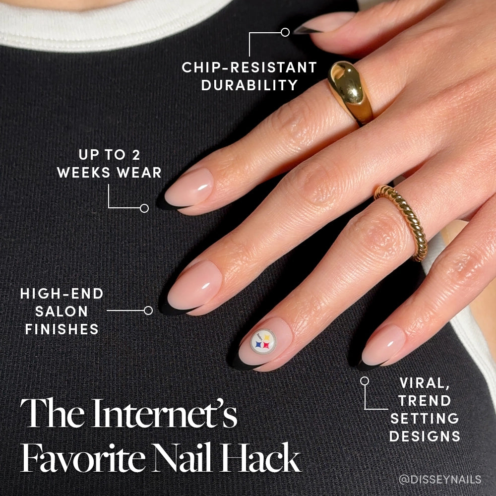 A hand with glossy, almond-shaped nails shows off the glamnetic Pittsburgh Steelers Press-On Nail Set—minimal nude manicure with a bold Steelers-inspired accent, chip-resistant durability, up to 2-week wear, and viral trendy finishes. - Product image