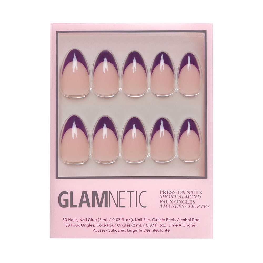 The glamnetic Plum press-on nails set features short almond-shaped nude nails with dark purple French tips. The box includes nail glue, a nail file, a cuticle stick, and an alcohol pad. - Product image