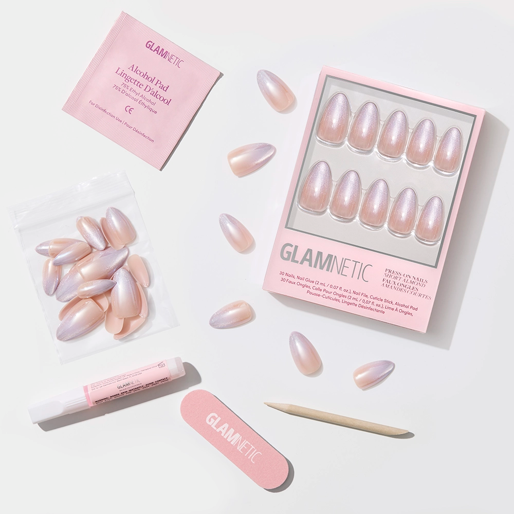 A flat lay of glamnetic’s Polar Day set, featuring short almond nails in glossy pink and velvet lilac, with nail glue, cuticle stick, file, alcohol pad, and extra nails—all arranged on a white background. - Product image