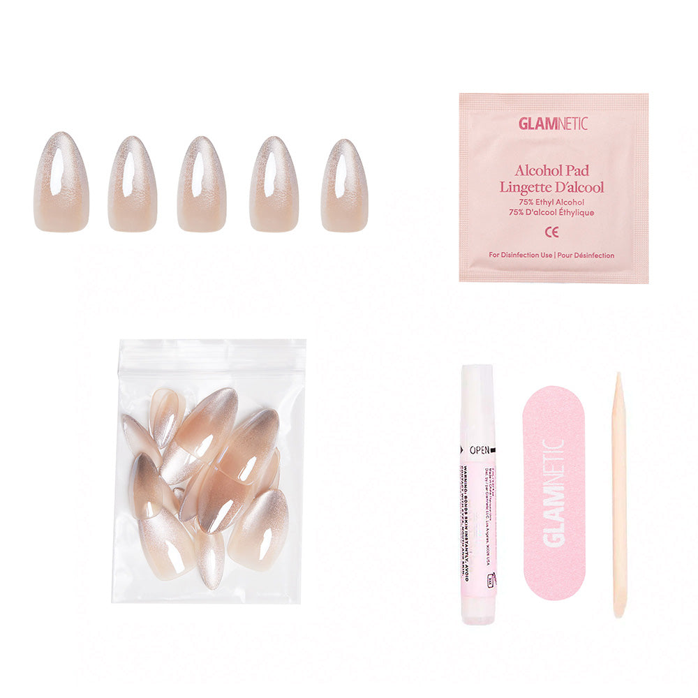 The glamnetic Polar Night set includes five nude and silver ombre almond nails with a glossy velvet finish, extra nails, an alcohol pad, nail glue, a pink nail file, and a wooden cuticle stick on a white background. - Product image