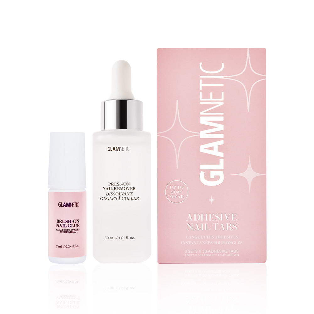 The glamnetic Press-On Perfection set includes a pink nail glue, nail remover dropper bottle, and a chic pink box of adhesive tabs with white and silver accents—everything you need for flawless press-on nails.