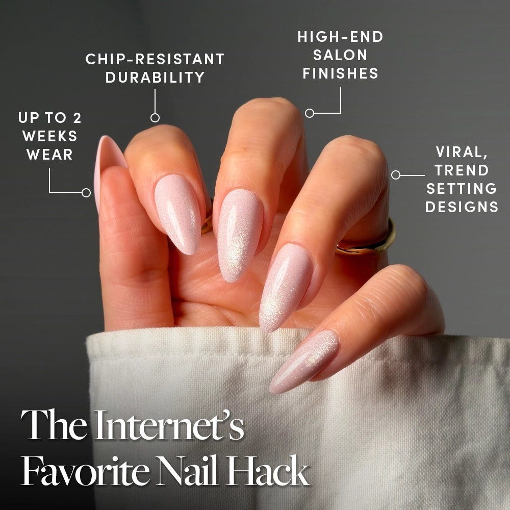 A hand shows off glamnetic's Promise Kept press-on nails—long, almond-shaped, glossy pink—featuring up to 2 weeks' wear, chip-resistant durability, luxe finishes, and viral trend-setting design. - Product image