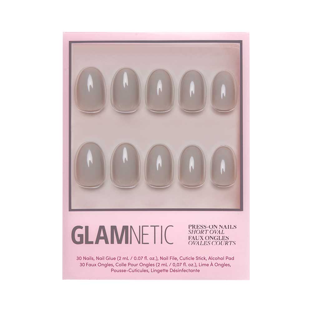 A box of glamnetic Pure Gray press-on nails in a short oval shape features glossy gray nails arranged in two rows inside chic pink packaging. - Product image