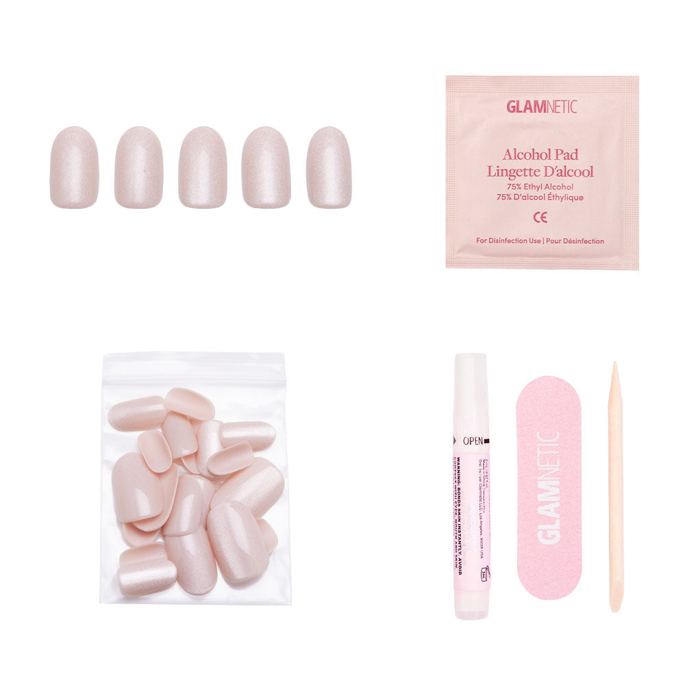 The glamnetic Pure Intentions Nail Set includes light pink iridescent reusable nails, extra nails, glue, a pink nail file, an alcohol pad, and a wooden cuticle stick—all arranged on a white background. - Product image