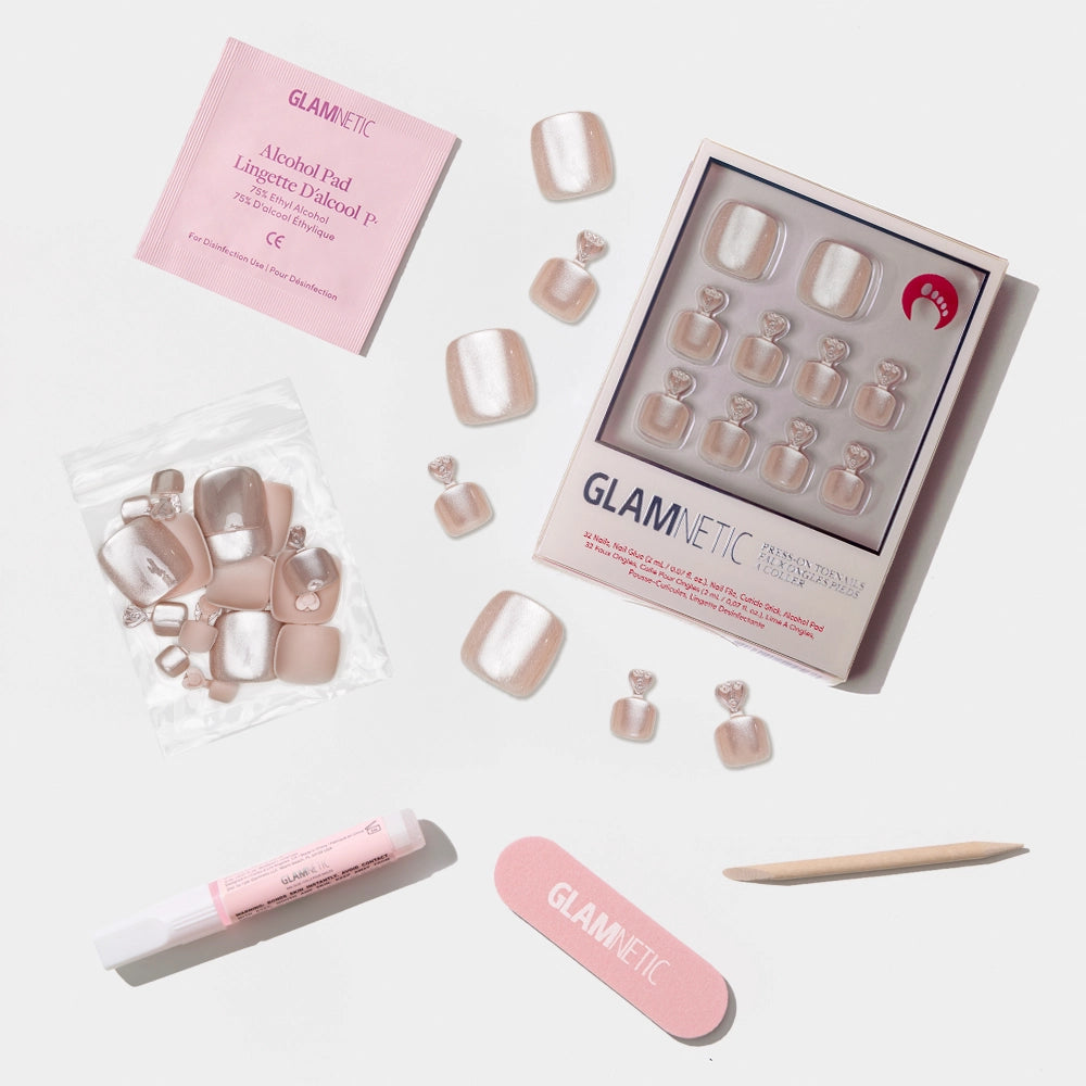 A flat-lay of the Glamnetic shimmer champagne press-on toenail kit with pearly shine and full application set. - Product image