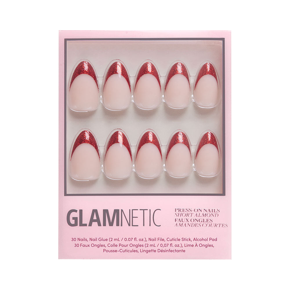 A box of glamnetic Red Affair press-on nails in a short almond shape, featuring a pink base and glitter French tips. The packaging showcases ten faux nails in two rows with labeled included items and product info. - Product image
