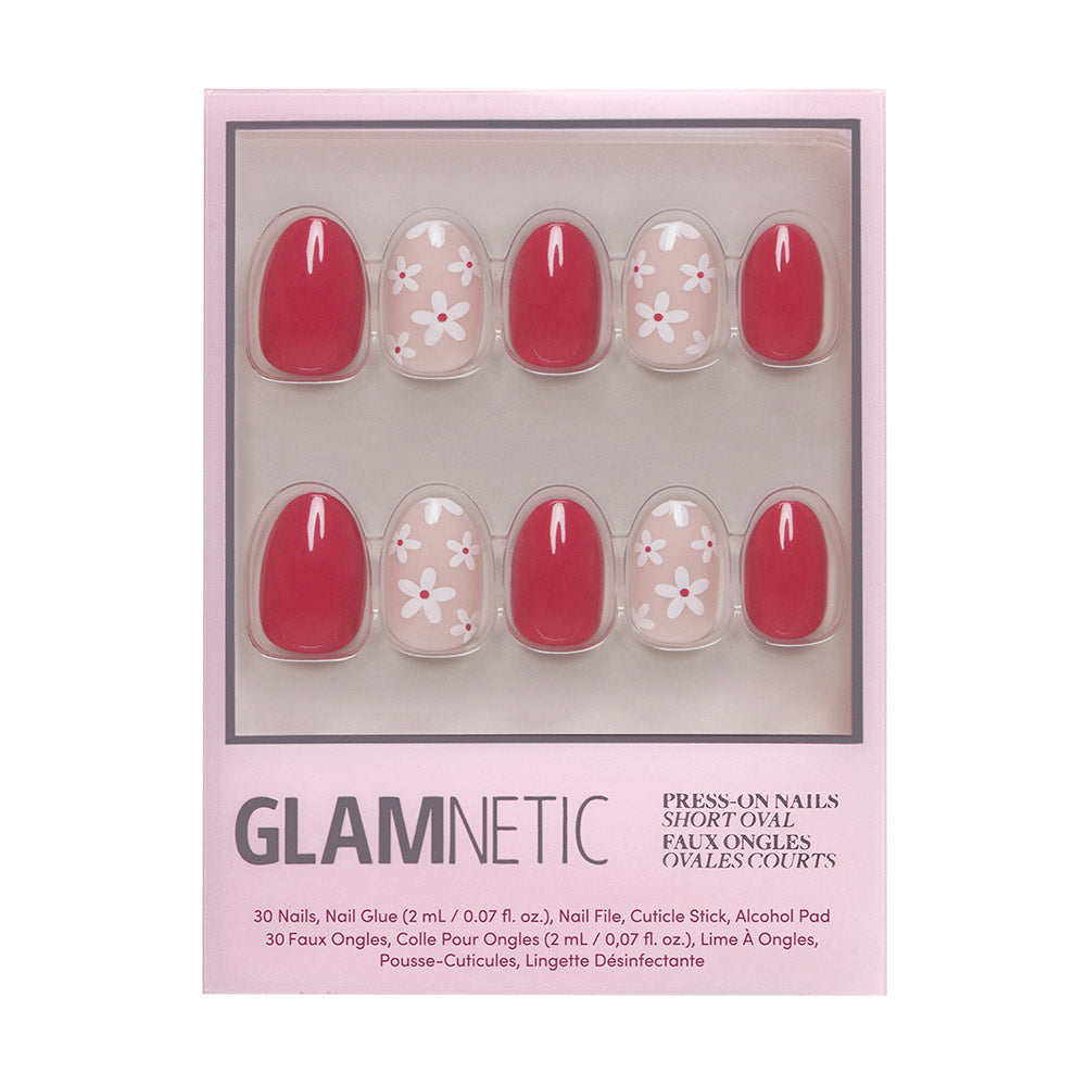 The glamnetic Red Blossom set includes 30 press-on nails in solid pink and floral designs with white daisies, plus nail glue, a nail file, cuticle stick, and alcohol pad.