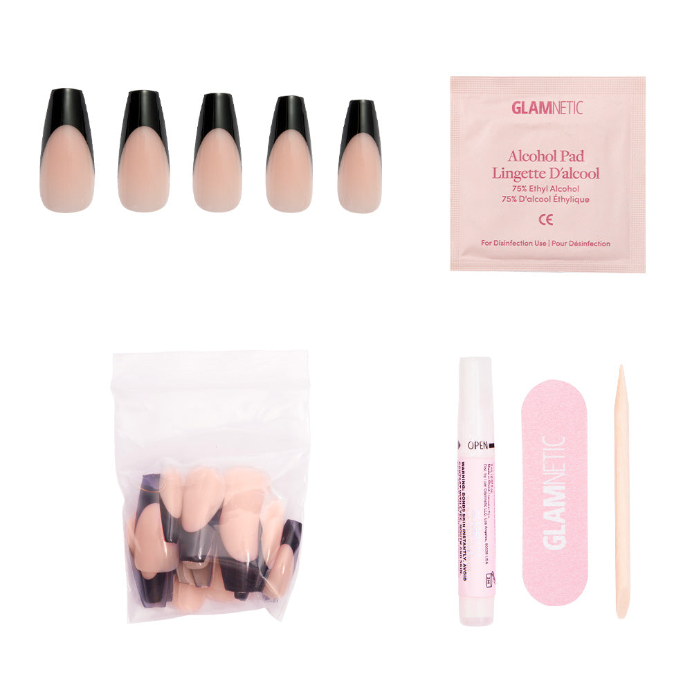 The glamnetic Rogue press-on nail kit includes five coffin-shaped nude and black French tip nails, extra vegan and cruelty-free nails, nail glue, an alcohol pad, a pink nail file, and a wooden cuticle stick—all on a white background. - Product image