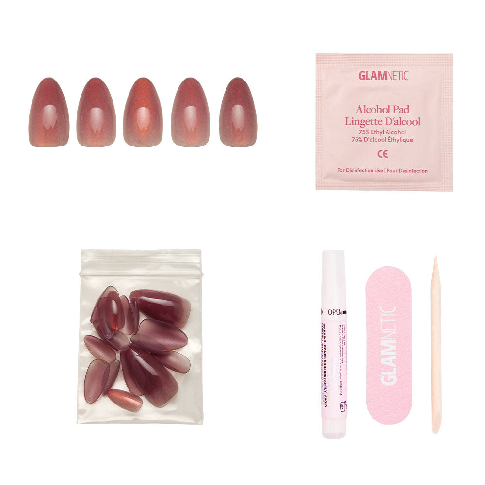 The glamnetic Rosé Nail Set includes short almond-shaped press-ons with a velvet metallic finish, an alcohol pad, extra nails in a pouch, nail glue, a pink nail file, and a wooden cuticle stick—all on a white background. - Product image