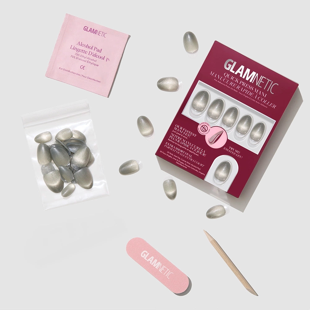 The glamnetic Sparkly Moss press-on nails with a metallic finish are shown on a light gray background, accompanied by a pink nail file, wooden cuticle stick, nail glue, alcohol pad, and extra nails. - Product image