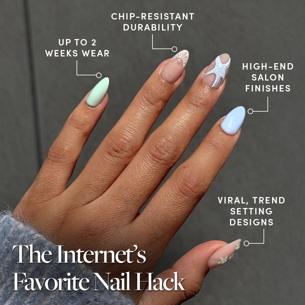 A hand with manicured short almond nails in various pastel colors and ocean-themed designs, featuring chip-resistant durability, up to 2 weeks wear, high-end finishes, and trend-setting style: Salty Waves by glamnetic—the Internet’s favorite press-ons. - Product image