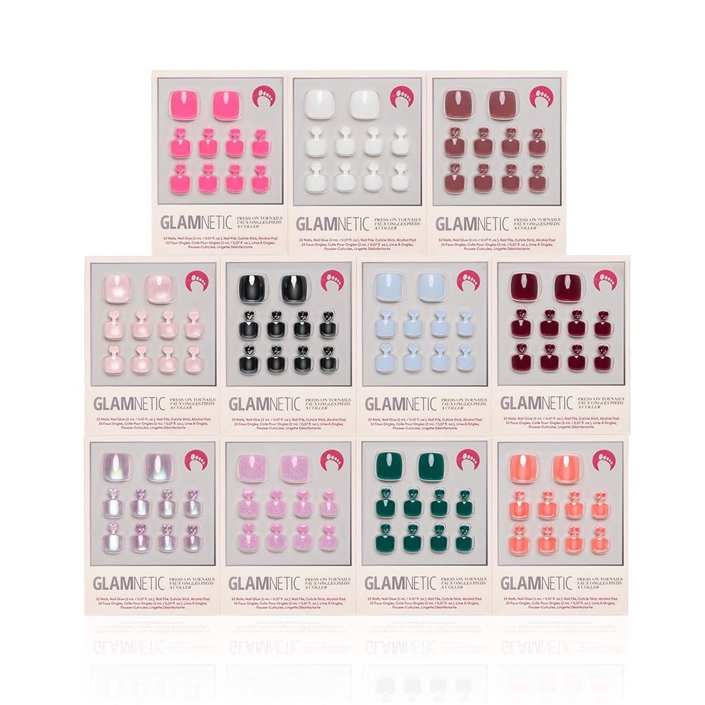 Ten boxes of glamnetic Sole Mates Pedi Bundle are arranged in two rows, each offering glossy press-on nails in pink, white, red, black, green, and glitter shades—ideal for a stylish summer pedicure. - Product image