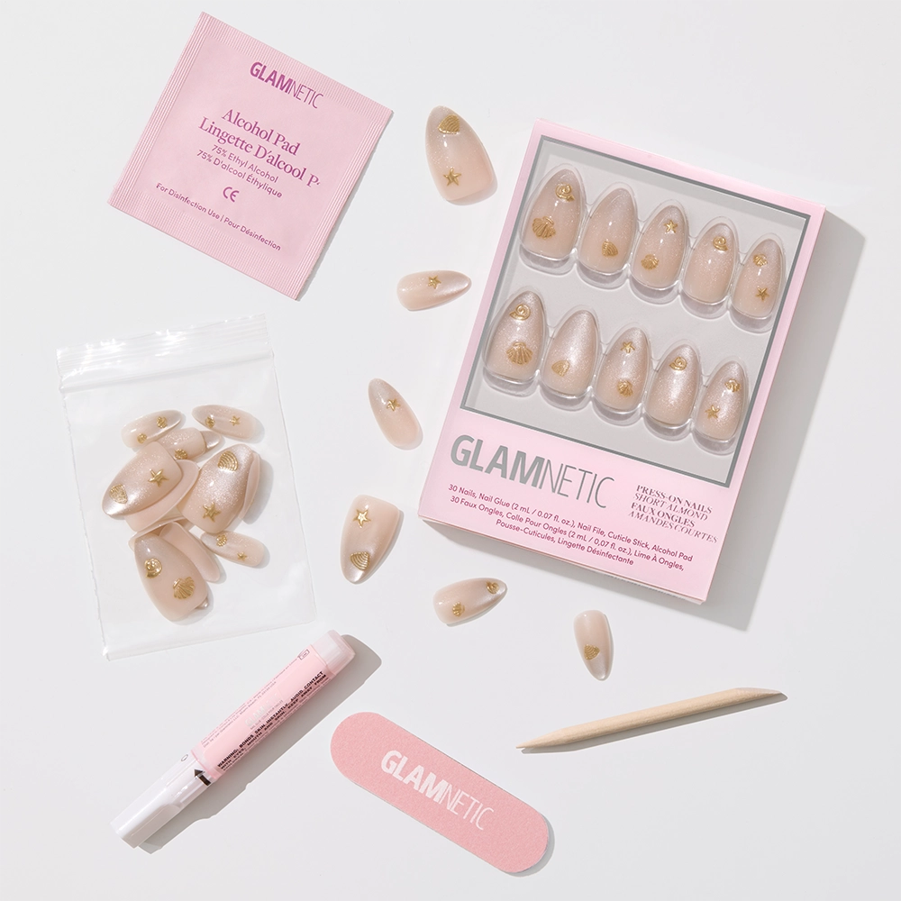 The glamnetic Sanded Press-On Nail Set includes nude nails with gold stars, a nail file, cuticle stick, glue, alcohol pad, and extra nails—all you need for a flawless beach-inspired manicure. - Product image