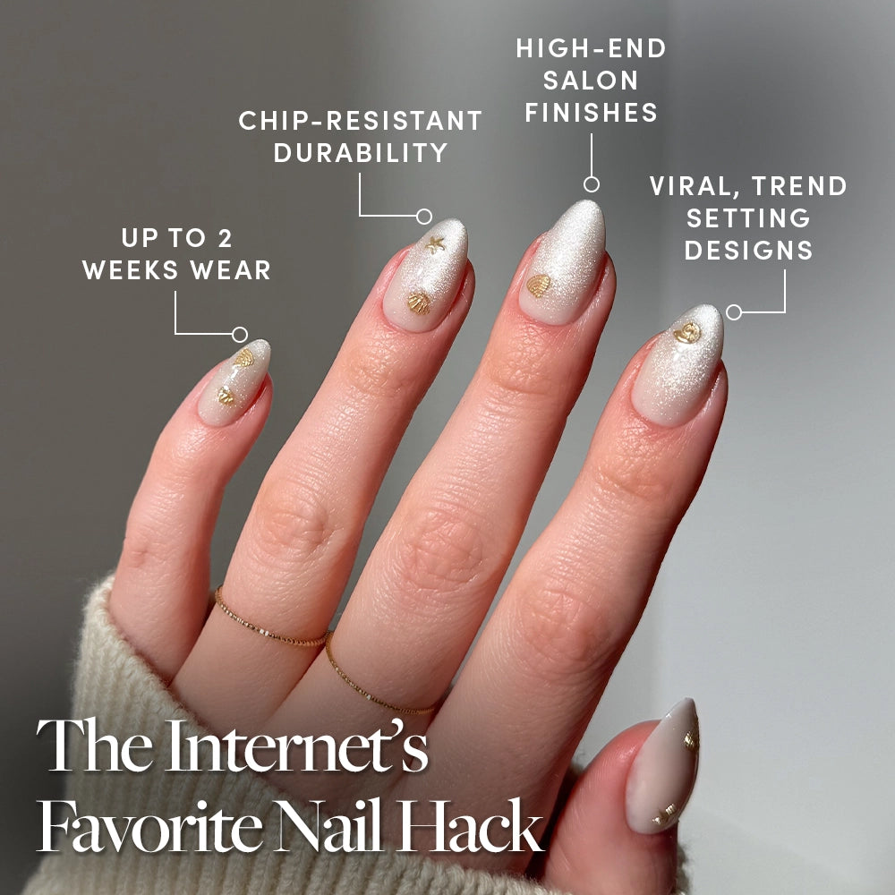A hand with almond-shaped nails in glamnetic’s Sanded, a shimmery white base with gold stars for mermaid vibes. Enjoy long-lasting, chip-resistant, trendy salon results. Text reads: The Internet’s Favorite Nail Hack. - Product image