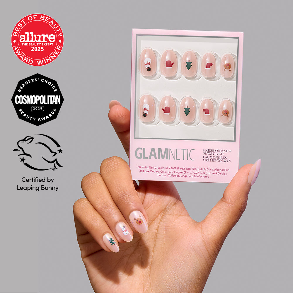 Santa's Babies - A hand holds a set of Santa’s Babies Glamnetic press-on nails decorated with Christmas icons, with matching designs worn on the fingers.