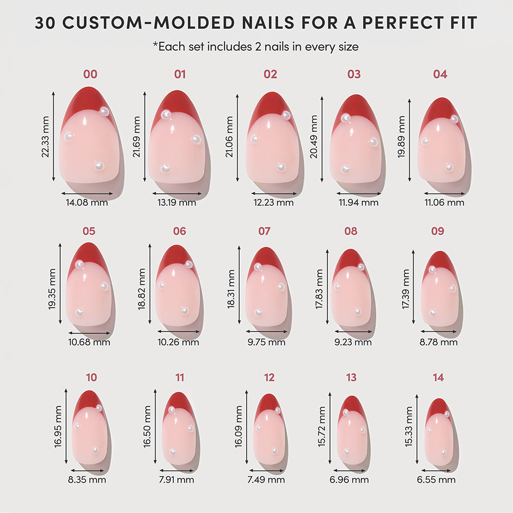 A size chart for Glamnetic Scarlet Pearl press-on nails, displaying 15 almond-shaped nails with light pink bases, red French tips, and a single pearl accent, including dimension labels for each size. - Product image