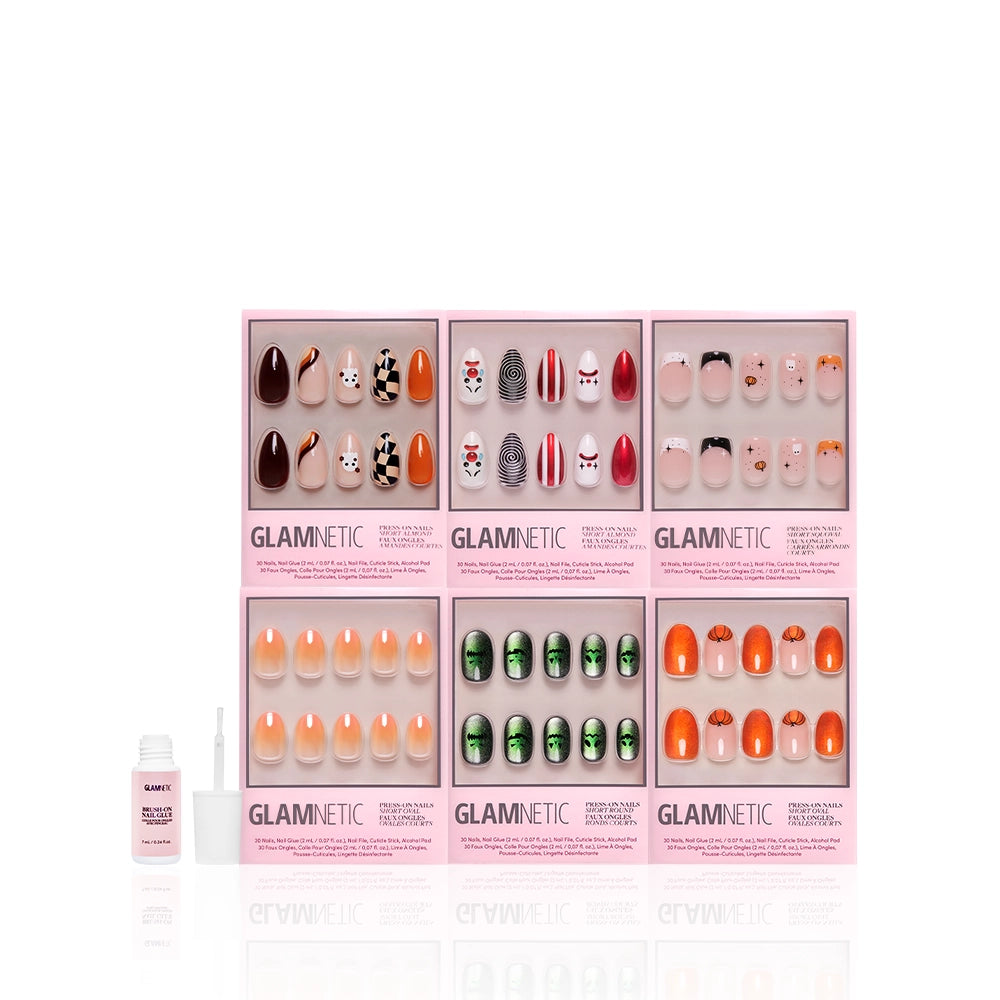 Five sets of glamnetic Scream Chic Halloween nails come in pink boxes with festive designs like pumpkins, ghosts, and Frankenstein. A nail file and a bottle of glue are included and placed on the left side. - Product image