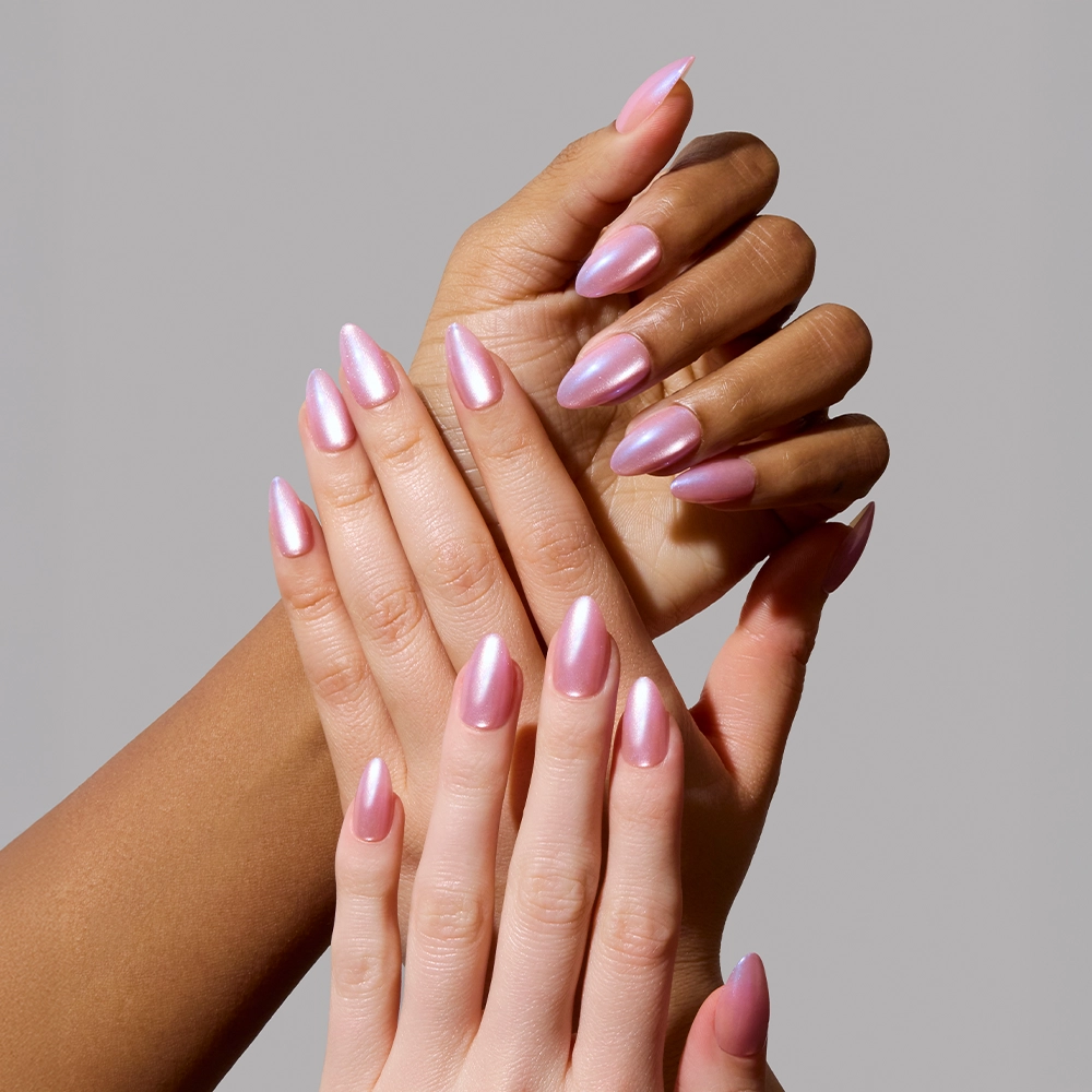 Three hands with long, almond-shaped nails painted in glamnetic’s Seaspell shimmer polish are displayed against a plain gray background, highlighting the glossy and elegant manicure. - Product image