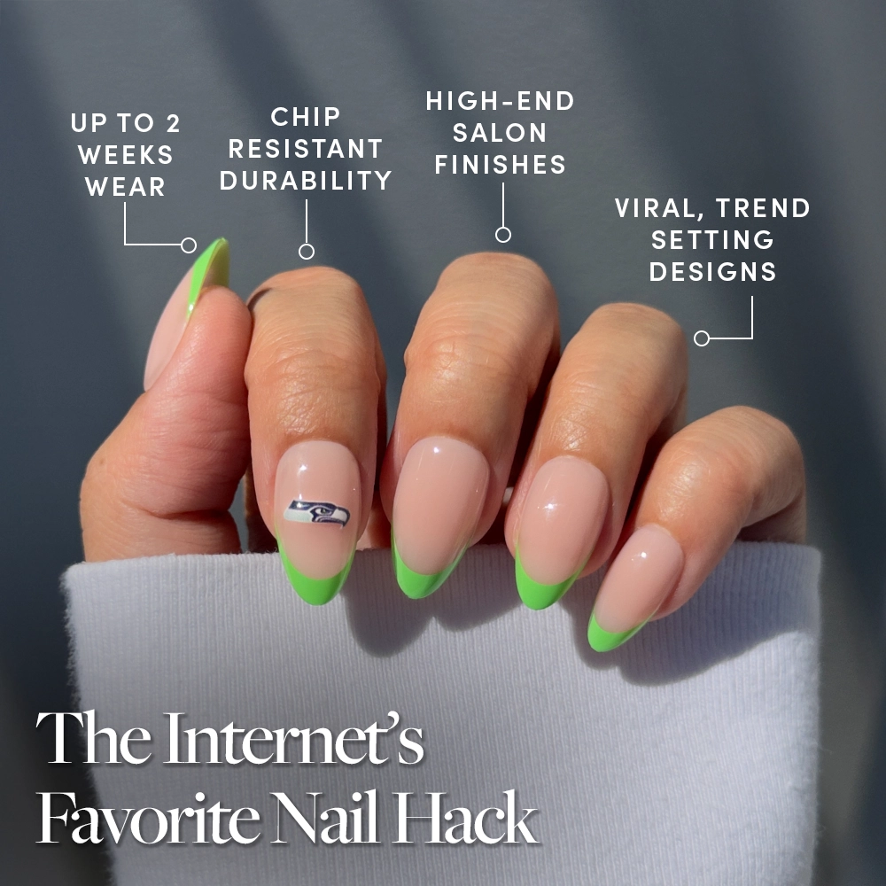 A hand with long almond-shaped nails in the Seattle Seahawks Press-On Nail Set by glamnetic, featuring neon green French tips and a silver car accent. Salon finish, durable wear, and fan favorite—The Internet’s Favorite Nail Hack. - Product image