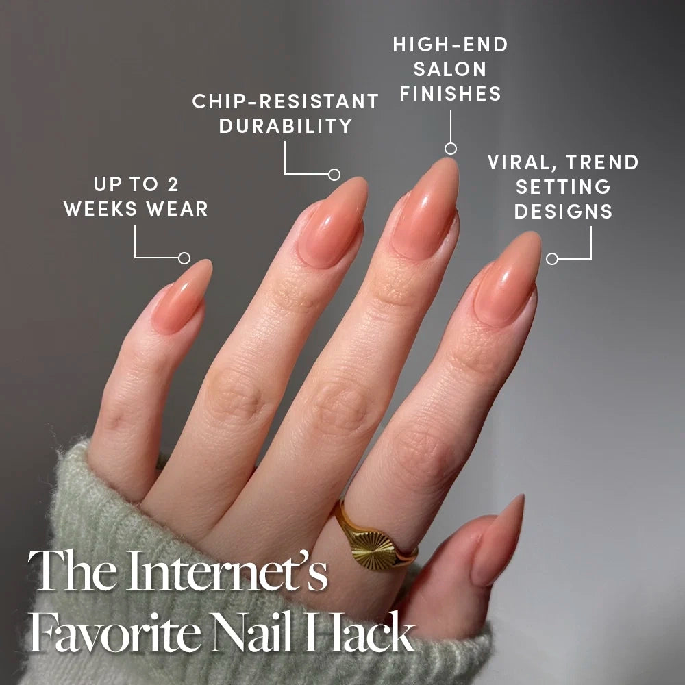 A hand with long, almond-shaped Sheer Peach nails by glamnetic is shown. Text highlights features: up to 2 weeks wear, chip-resistant durability, high-end salon finishes, and viral trend-setting designs. These cruelty-free nails offer a luxurious look while being kind to animals. A gold ring adorns one finger. - Product image