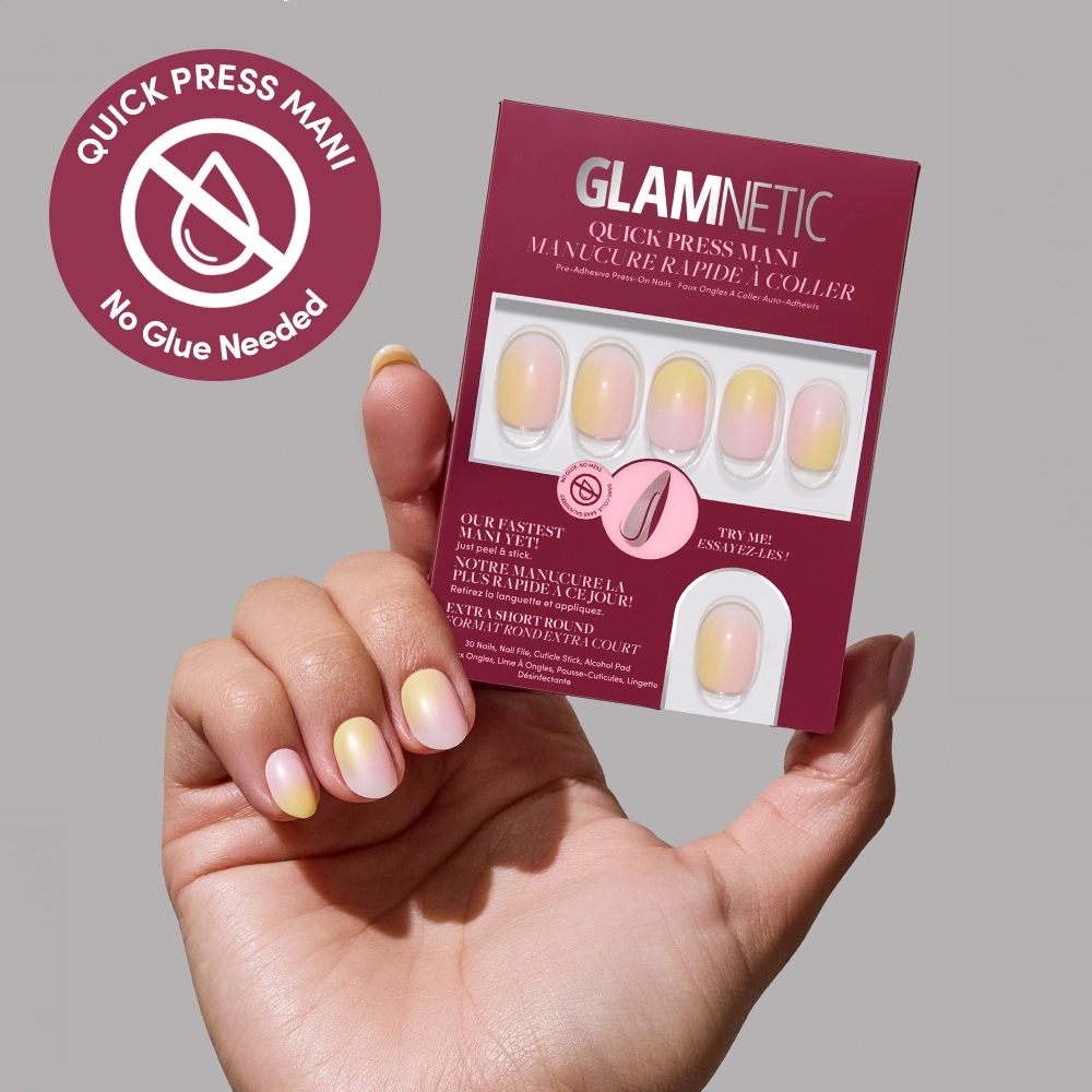A hand with ombre pastel pink and yellow Sherbert stick-on nails holds a glamnetic Quick Press Mani box. A “Quick Press Mani, No Glue Needed” badge is shown in the top left corner on a light mauve background.