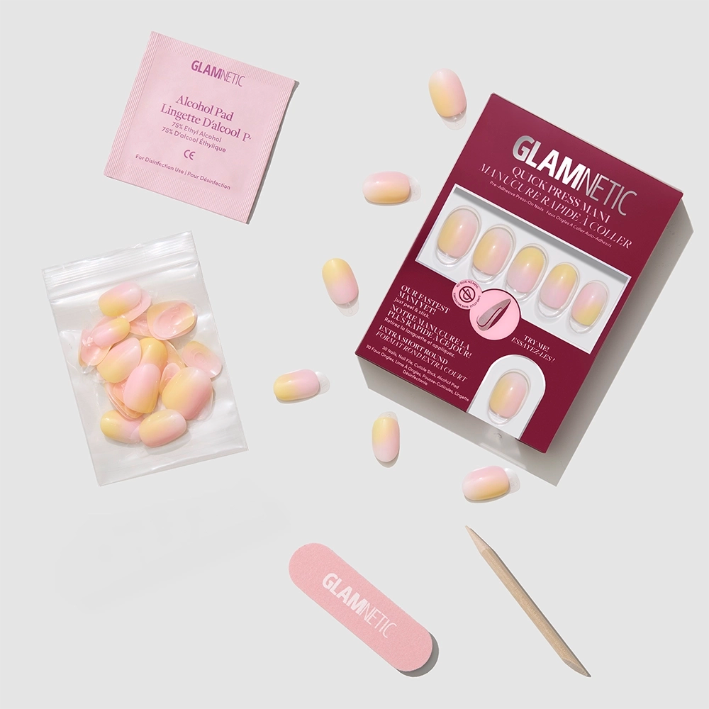 The glamnetic Sherbert set includes press-on nails, a pink nail file, wooden cuticle stick, nail glue tube, alcohol pad, and extra stick-on nails displayed on a light gray background. - Product image