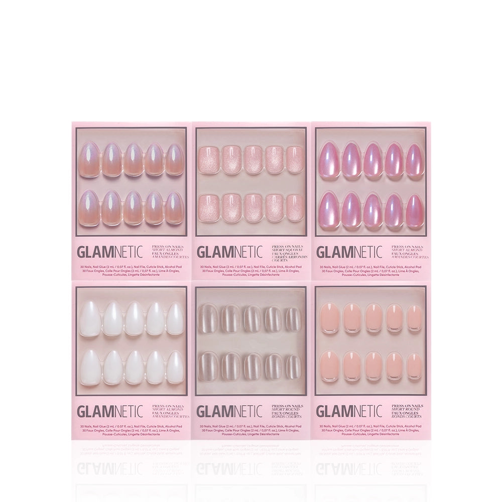 The Glamnetic Shimmer Soiree Bundle includes six boxes of press-on nails with short almond styles in pink, nude, white, and glitter shades. Each box features unique designs and shapes, arranged in two rows against a white background. - Product image