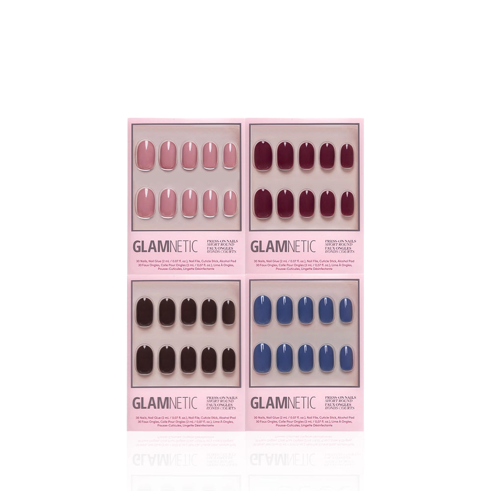 Four packs of the glamnetic Short Round Study Set, salon-quality press-on nail sets, in pink, burgundy, dark brown, and blue jewel-tone shades. Each set features short round press-on nails neatly arranged inside signature pink glamnetic packaging against a white background. - Product image