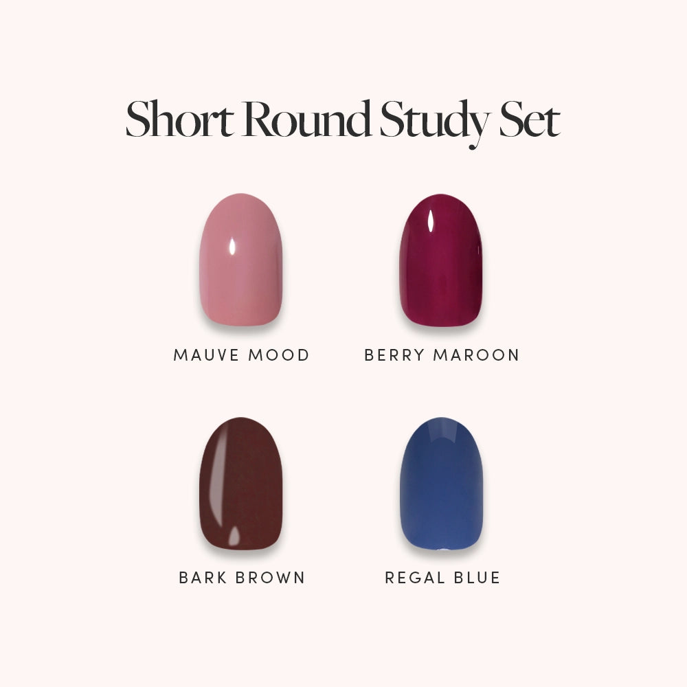 Four nail polish swatches—Mauve Mood (light pink), Berry Maroon (dark red), Bark Brown (dark brown), and Regal Blue (medium blue)—are displayed on a light background with “Short Round Study Set” text above. This elegant collection from glamnetic features jewel-toned, short round press-on nails expertly crafted to deliver salon-quality results for an effortlessly stylish and sophisticated look. - Product image